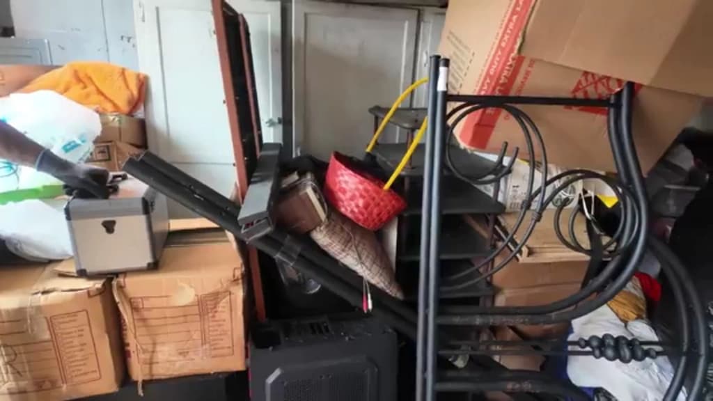 Furniture, boxes and a bed frame left behind in a unit before a turnover clearout